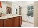 Bright bathroom featuring a brown vanity, floral shower curtain and an abundance of natural light at 12884 Calderdale Ave, Windermere, FL 34786