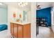 Bright bathroom with a double vanity connecting to a cozy bedroom and a study area, blending comfort and functionality seamlessly at 12884 Calderdale Ave, Windermere, FL 34786