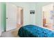 Cozy bedroom with a blue comforter on the bed and access to the ensuite bathroom at 12884 Calderdale Ave, Windermere, FL 34786