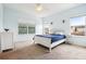 Inviting bedroom boasts ample natural light, a comfortable bed, and neutral walls, creating a calming and serene atmosphere at 12884 Calderdale Ave, Windermere, FL 34786