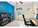 Comfortable bedroom features built-in shelving and a natural-light-filled study area, creating an ideal atmosphere for work or relaxation at 12884 Calderdale Ave, Windermere, FL 34786