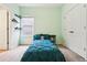 Inviting bedroom with a window, a small side table, and a soft blue bed cover at 12884 Calderdale Ave, Windermere, FL 34786