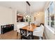Dining room with a modern light fixture and wooden dining table located off of the kitchen at 12884 Calderdale Ave, Windermere, FL 34786