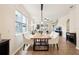 Bright dining area featuring a wooden table, white upholstered chairs, and large windows at 12884 Calderdale Ave, Windermere, FL 34786