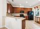 Well-equipped kitchen with wooden cabinets, modern appliances, and tiled floors offers functionality at 12884 Calderdale Ave, Windermere, FL 34786