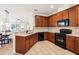 This kitchen features wooden cabinets, tiled backsplash, modern appliances, and spacious countertops at 12884 Calderdale Ave, Windermere, FL 34786