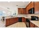 Featuring wooden cabinets, a tiled backsplash, modern appliances and spacious countertops, this kitchen shines at 12884 Calderdale Ave, Windermere, FL 34786