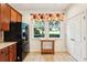 Bright kitchen showing stainless steel refrigerator, a large window and tile flooring with a double door pantry at 12884 Calderdale Ave, Windermere, FL 34786