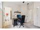 Well-lit office space with an open doorway into an adjacent bathroom, providing convenience and functionality for the work environment at 12884 Calderdale Ave, Windermere, FL 34786