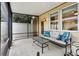 Inviting screened patio featuring a cozy sofa, glass table, and views of the fenced backyard at 12884 Calderdale Ave, Windermere, FL 34786