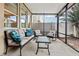 Relaxing screened patio with comfortable seating, a glass table, and views of the surrounding yard at 12884 Calderdale Ave, Windermere, FL 34786