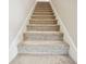 Carpeted staircase with white trim provides a transition between floors, offering both comfort and a clean, neutral aesthetic at 12884 Calderdale Ave, Windermere, FL 34786