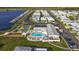 Aerial view of the community featuring a pool, shuffleboard, waterfront access, and mature landscaping at 1401 W Highway 50 # 152, Clermont, FL 34711