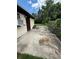Backyard area featuring a concrete patio, grass, and wooded area at 1425 26Th St, Orlando, FL 32805