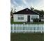 Modest home featuring a white picket fence and neutral color scheme at 1425 26Th St, Orlando, FL 32805