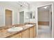 Bathroom with double sinks, large mirror, and access to the shower and closet at 14332 Grassy Cove Cir, Orlando, FL 32824