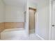 Bathroom showcasing tub, shower, and tile accents at 14332 Grassy Cove Cir, Orlando, FL 32824