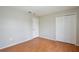 Spacious bedroom featuring wood floors and a double door closet at 14332 Grassy Cove Cir, Orlando, FL 32824