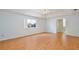 Sunlit bedroom with wood floors, tray ceiling, and ample space at 14332 Grassy Cove Cir, Orlando, FL 32824