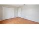 Bedroom with laminate floors, a closet with bifold doors, and a doorway at 14332 Grassy Cove Cir, Orlando, FL 32824