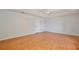 Spacious bedroom featuring wood floors, a white ceiling fan, and neutral walls at 14332 Grassy Cove Cir, Orlando, FL 32824