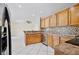 Well-equipped kitchen features wood cabinets, mosaic tile backsplash, and stainless steel appliances at 14332 Grassy Cove Cir, Orlando, FL 32824