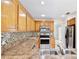 The functional kitchen with wood cabinets, stainless steel appliances, and access to dining area at 14332 Grassy Cove Cir, Orlando, FL 32824