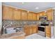 The well-maintained kitchen featuring wood cabinets, modern appliances, and a stylish backsplash at 14332 Grassy Cove Cir, Orlando, FL 32824