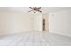 Open living room with white tile flooring, ceiling fan, and neutral paint at 14332 Grassy Cove Cir, Orlando, FL 32824