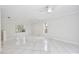 Bright, spacious living area featuring tile flooring, natural light, and views of the outdoor landscape at 14332 Grassy Cove Cir, Orlando, FL 32824