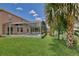Spacious backyard features a screened pool, lush landscaping, and ample green space at 14332 Grassy Cove Cir, Orlando, FL 32824
