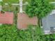 An aerial view shows the brown roof and tree coverage of this single-Gathering home at 14402 Sw 34Th Terrace Rd, Ocala, FL 34473