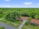 Aerial view of a home with mature trees, well-kept lawn, and a driveway leading to an attached garage at 14402 Sw 34Th Terrace Rd, Ocala, FL 34473