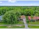 Aerial view of home featuring mature tree, front lawn, and a driveway leading to a single car garage at 14402 Sw 34Th Terrace Rd, Ocala, FL 34473