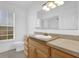 Bright bathroom featuring a vanity with a sink, neutral-colored countertop, and a large framed mirror at 14402 Sw 34Th Terrace Rd, Ocala, FL 34473