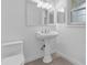 Bathroom features tiled floors, white walls, and pedestal sink at 14402 Sw 34Th Terrace Rd, Ocala, FL 34473