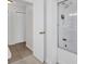 Bathroom view showing an updated glass door shower, tile floors, and a nearby closet at 14402 Sw 34Th Terrace Rd, Ocala, FL 34473