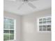 Bright bedroom featuring neutral walls and two windows with blinds offering natural light at 14402 Sw 34Th Terrace Rd, Ocala, FL 34473