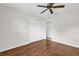Clean bedroom showcasing a ceiling fan, hardwood floors, and a closet with mirrored sliding doors at 14402 Sw 34Th Terrace Rd, Ocala, FL 34473
