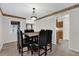 Dining room with a dark table set and seamless access to the kitchen, with neutral walls and tile floors at 14402 Sw 34Th Terrace Rd, Ocala, FL 34473