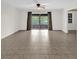 Spacious living room with tile flooring, sliding glass doors, and neutral wall color at 14402 Sw 34Th Terrace Rd, Ocala, FL 34473