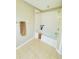 Bathroom featuring a tub and shower combination, neutral walls, and tiled floors creating a functional space at 15258 Windmill Harbor Ct, Orlando, FL 32828