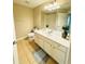 Spacious bathroom featuring a double vanity, a large mirror, and neutral tile flooring at 15258 Windmill Harbor Ct, Orlando, FL 32828