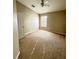 Neutral-colored bedroom with carpet, ceiling fan, a window for natural light, and a door for privacy at 15258 Windmill Harbor Ct, Orlando, FL 32828