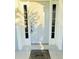 Welcoming front door featuring sidelights and a 