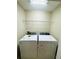 This convenient laundry room includes a modern washer and dryer set with overhead shelving at 15258 Windmill Harbor Ct, Orlando, FL 32828