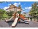 Community playground featuring slides, climbing structures, and shaded seating areas at 15258 Windmill Harbor Ct, Orlando, FL 32828