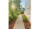 View of sidewalk, lush greenery, and sunlight cascading through the trees at 15258 Windmill Harbor Ct, Orlando, FL 32828