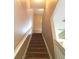 Carpeted stairway with white railing leading upstairs, neutrally painted walls, and landing area at 15258 Windmill Harbor Ct, Orlando, FL 32828