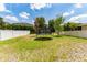 Expansive backyard featuring a trampoline and a white fence, perfect for outdoor activities at 15716 Sweet Lemon Way, Winter Garden, FL 34787